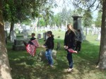 children decorate graves.