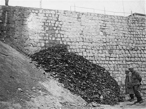 After the liberation of the Flossenbürg concentration camp, two U.S. army infantrymen examine a pile of shoes belonging to victims of the camp. Flossenbürg, Germany, May 1945.After the liberation of the Flossenbürg concentration camp, two U.S. army infantrymen examine a pile of shoes belonging to victims of the camp. Flossenbürg, Germany, May 1945. USHMM