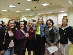 Students Chelsea R., Paige L., Meg V., Cheyenne B., Mary R. flank survivor Clara Rudnick at reception following Yom Hashoah commemoration, 2014.